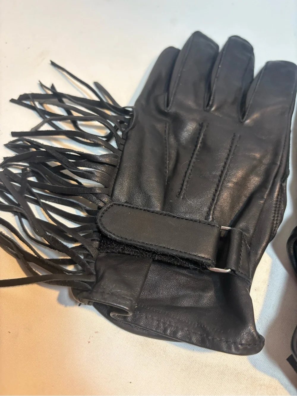 Women’s black leather motorcycle gloves fringe detailing adjustable closure